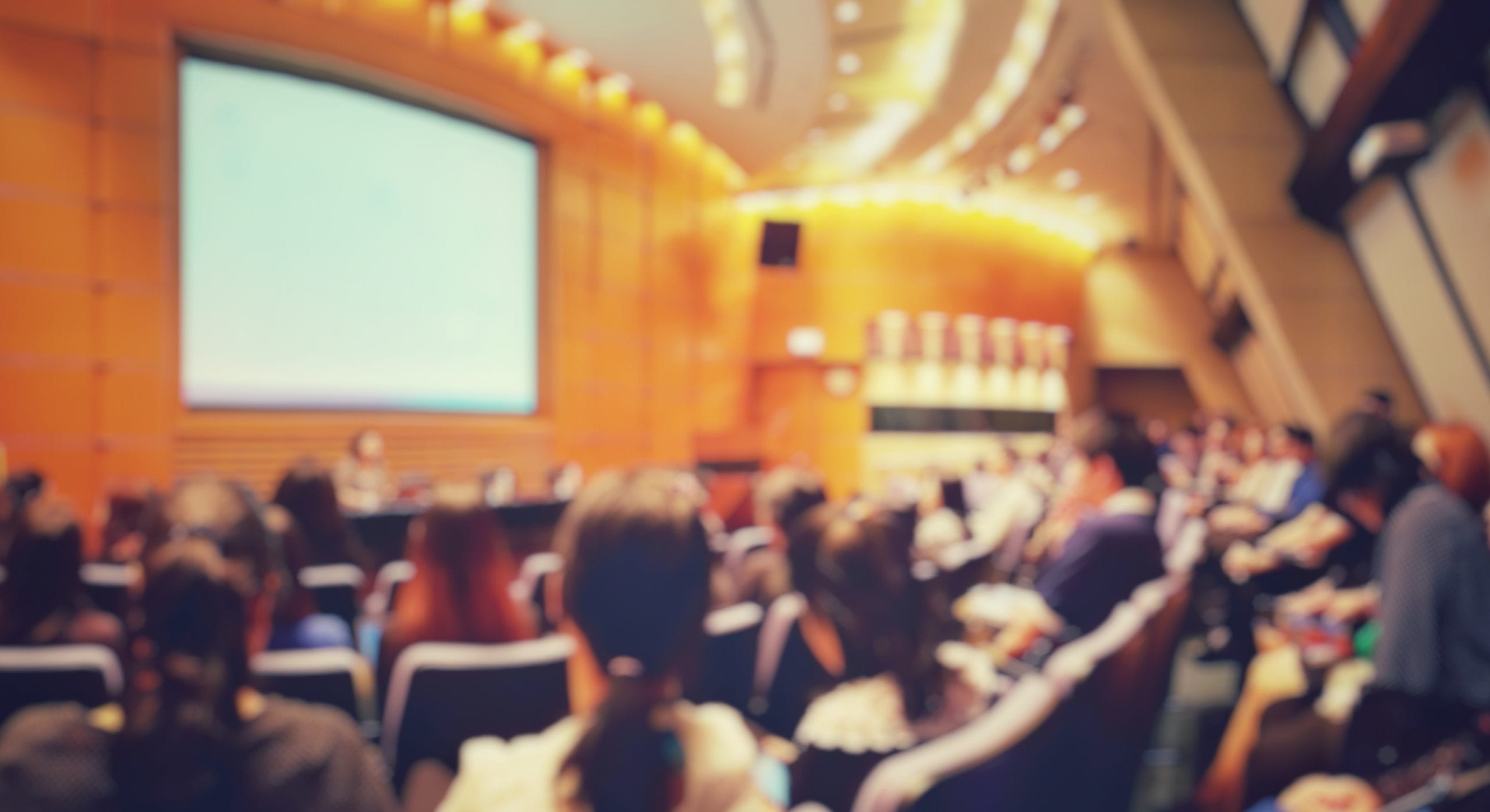 Blur of people in auditorium room