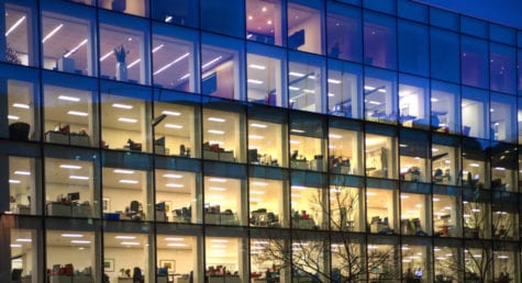 Late office workers in LED lit office building