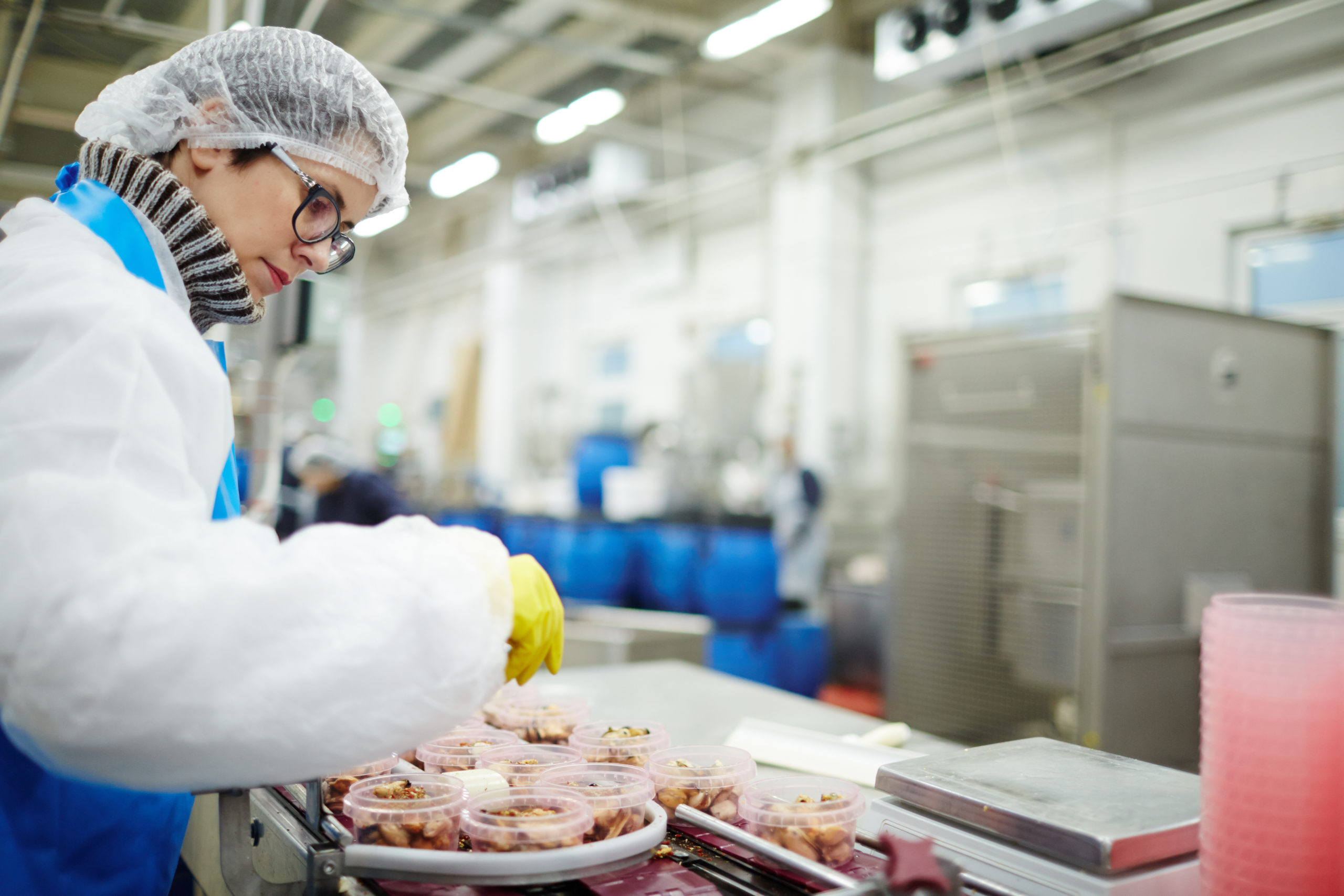 Woman sorting seafood into plastic containers