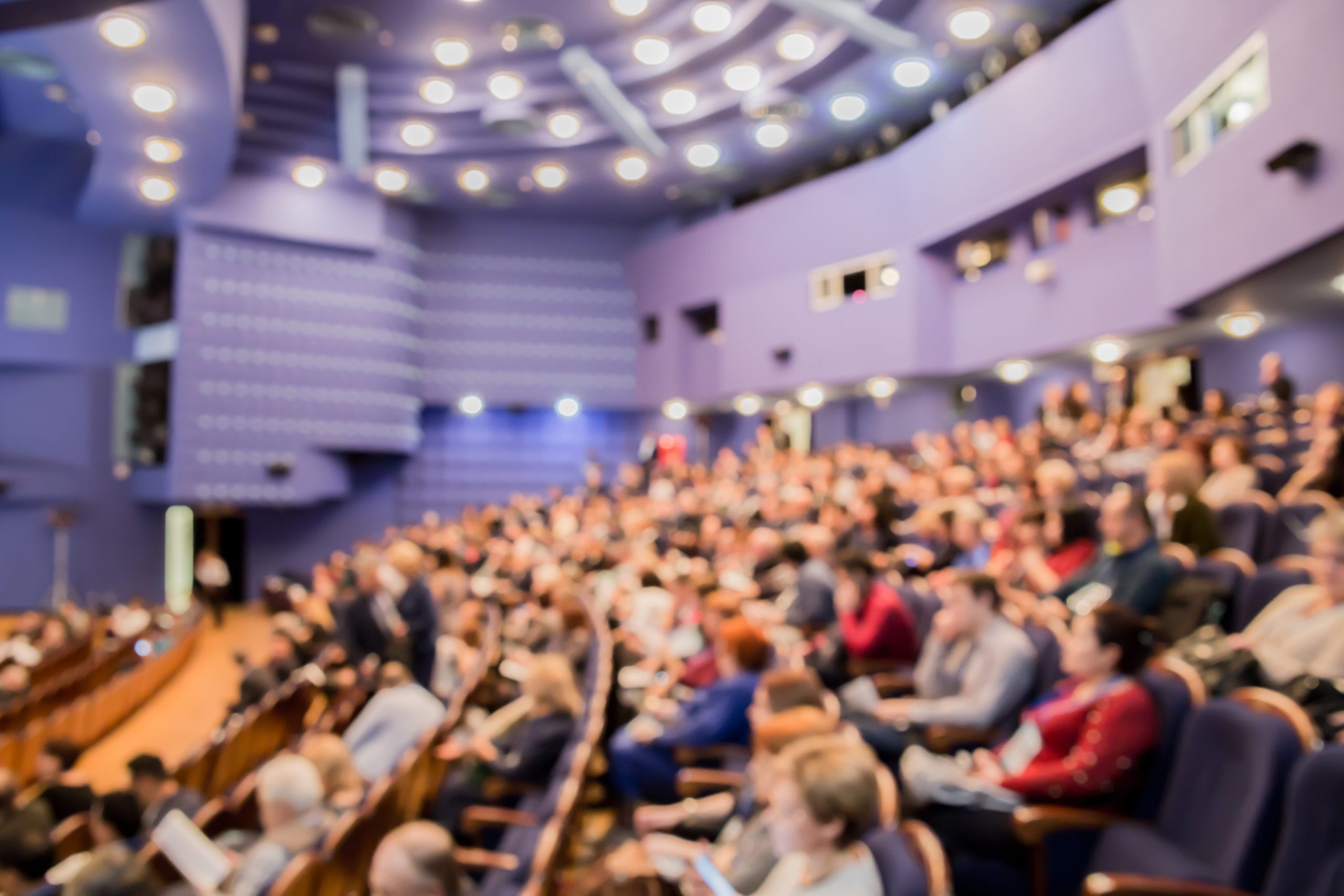 People in the auditorium during a conference